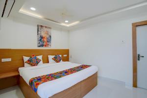 a bedroom with a large bed in a room at FabHotel MV Luxury Rooms in Hyderabad