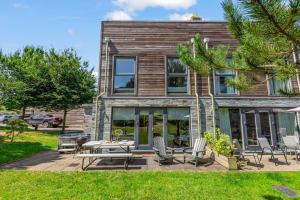 a patio with chairs and a table in front of a building at House 8 in Looe