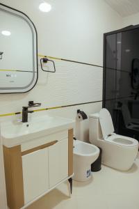 a bathroom with a toilet and a sink and a mirror at Aida hotel PREMIUM in Bukhara +65 photos