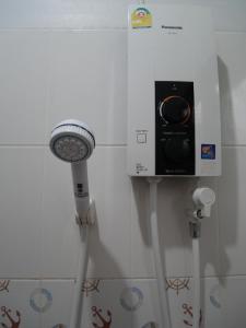 a shower with a light attached to a wall at นากลางดอย Naklangdoi in Ban Na Kham +35 photos
