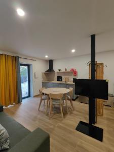 a living room with a table and a kitchen at Gondar Stays Estúdio  +3 photos