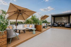 an outdoor patio with chairs and an umbrella at Auris Hotel & Restobar in Almaty