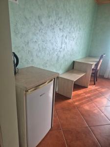 a room with two tables and a table and chairs at Gintolina in Kazlų Rūda