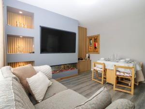 a living room with a couch and a table at 6 Niddrie Marischal Road in Edinburgh
