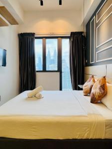 a bedroom with a bed with a view of the city at The Luxe Service Suites in Kuala Lumpur +80 photos