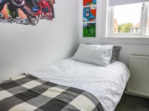 a small bedroom with a bed and a window at 6 Niddrie Marischal Road in Edinburgh