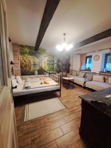 a living room with a couch and a painting on the wall at Kúria Apartman Budapest with free parking in Budapest