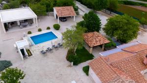 an overhead view of a house with a swimming pool at Wellnes Villa Silentio With Pool in Duge Njive