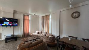 a living room with a couch and a table at Guest House in Batumi