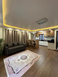 a living room with a couch and a kitchen at Heritage Service Apartment in Pātan +17 photos