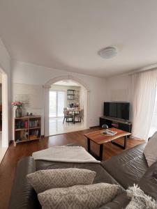 a living room with a couch and a table at seaview apartment - villa a’more in Milna