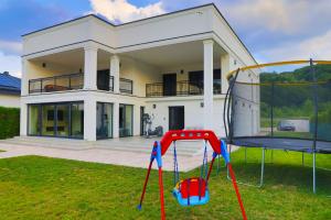 a house with a playground in front of it at Casa Dellˇ Amore in Bihać