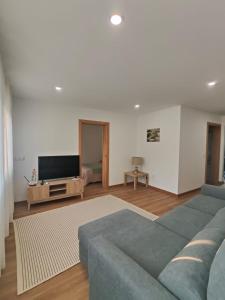 a living room with a couch and a flat screen tv at Gondar Stays T1 