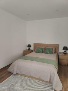 a bedroom with a large bed with two night stands at Gondar Stays T1 