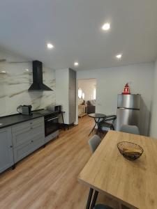 a kitchen with a wooden table and a dining room at Gondar Stays T1 