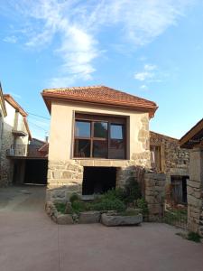 a house with a large window on top of it at As Casiñas da Mina in Fechas