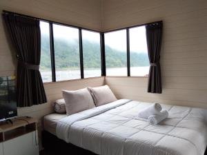 a bedroom with a bed with a teddy bear on it at Beji Bedugul Glamping in Bedugul