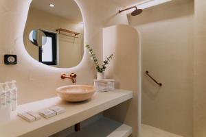 a bathroom with a sink and a mirror at Ichos Boutique Apartments in Volissos