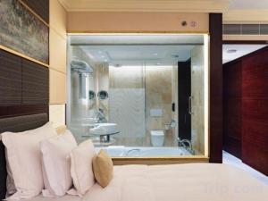 a bedroom with a bath tub and a bed with pillows at StarWorld Hotel in Macau +53 photos