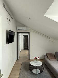 a living room with a couch and a table at Melo in Plombières