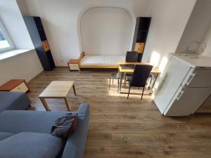a room with a couch and a table with a mirror at Apartamenty Floris Bochnia in Bochnia