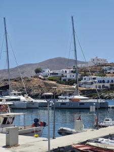 a group of boats are docked in a harbor at Faros House Kythnos in Loutra