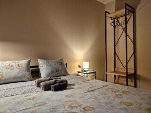 a bedroom with a large bed with two pillows at Podil-House-Hotel in Kyiv
