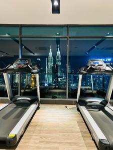 a gym with a view of the empire state building at The Luxe Service Suites in Kuala Lumpur