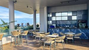 a restaurant with tables and chairs and a bar at Anthonian Suites in Accra