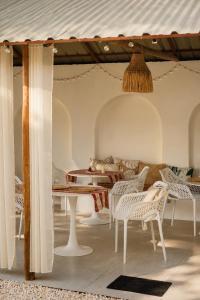 a room with white chairs and a table at CASA BUKO Tropical Homes El Nido in El Nido