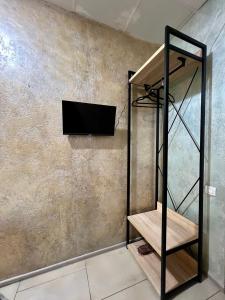 a room with a tv on a wall with a shelf at Podil-House-Hotel in Kyiv +117 photos