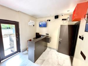 a room with a kitchen with a sink and a door at Hotel Fivetel in kolkata
