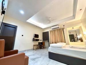 a hotel room with a bed and a mirror at Hotel Fivetel in kolkata +18 photos