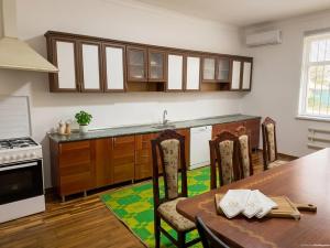 a kitchen with a table and a counter top at Хостел18А in Nukus