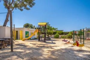 a playground with a slide and play equipment at Cabot Club Torreblanca in Sa Coma