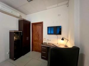 a room with a desk with a computer and a television at Podil-House-Hotel in Kyiv