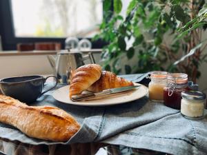 a table with a plate of bread and a cup of coffee at La Cour Tellier in Rilly-la-Montagne +22 photos