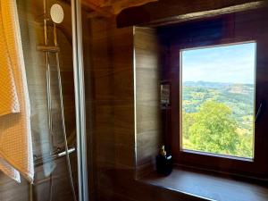 a bathroom with a shower with a window at La casa de Tio Mines in Regolfo +58 photos