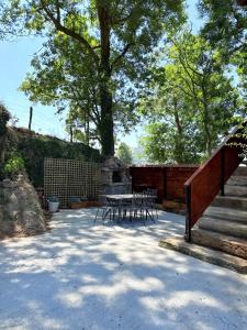 a patio with a table and chairs and stairs at La casa de Tio Mines in Regolfo