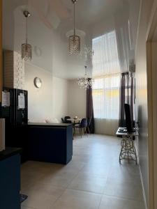 a living room with a desk and a table with chairs at Французский Бульвар ЖК Париж in Odesa