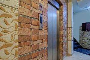 a brick wall with a door and a staircase at Collection O The Legend Hotel, Hisar in Hisār