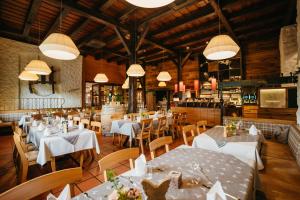a restaurant with white tables and chairs and lights at Hotel Hirsch in Neu-Ulm