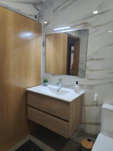 a bathroom with a sink and a mirror at Gondar Stays T2 