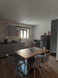 a kitchen with a wooden table and chairs at Gondar Stays T2 