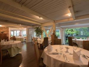 a dining room with tables with white tablecloths at Auberge de Primavera in Karuizawa +34 photos