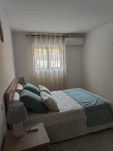 a bedroom with a large bed and a window at Gondar Stays T2 
