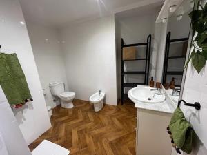 a bathroom with a toilet and a sink at Casa de los Yayos in Vélez de Benaudalla +15 photos