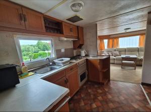 a kitchen with a sink and a counter top at Juno Holiday in Mrągowo