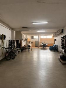 an empty living room with bikes and tables in it at Casa de los Yayos in Vélez de Benaudalla