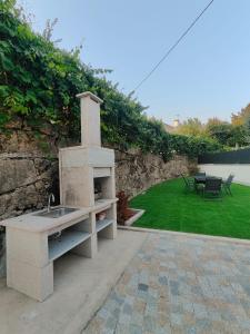 a outdoor kitchen with a stone stove in a yard at Gondar Stays T2 